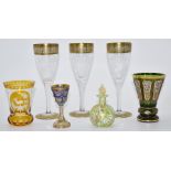 Six various drinking glasses comprising a set of three Moser style wine glasses with gilt decoration