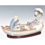 Lladro figural group Love Boat of a family with dog in rowing boat named Amour on wooden base,