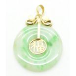 A 14ct gold pendant set with a jadeite bi-disc and character decoration to the centre, 2.5cm