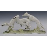 Heutschenreuther figure of three greyhounds racing, signed H Achtziger to base, W51 x H25cm