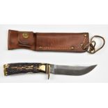Schrade 497 hunting knife with 11cm blade and leather sheath. PLEASE NOTE ALL BLADED ITEMS ARE