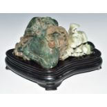 Chinese carved jade / jadeite boulder with lizard and fungi decoration, on wooden stand, W26 x D12 x