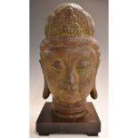 Chinese bronze bust of Guanyin on rosewood stand, 32cm tall.