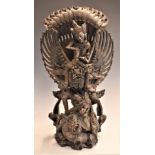 Balinese finely carved figure of the Hindu god Vishnu rinding Garuda, 42cm tall.