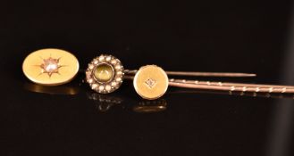 Three Victorian stick pins, one set with a split pearl, one a diamond and the other chrysoberyl