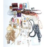 A collection of costume jewellery including tiger's eye necklace, vintage brooches, filigree