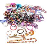 A collection of costume jewellery including beads, mother of pearl necklace, tiger's eye pendant,