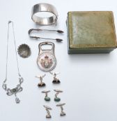 A collection of silver jewellery including bangle, tongs, bottle opener, marcasite brooch and