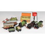 Twelve Hornby 0 gauge clockwork locomotives, rolling stock, buildings and accessories.