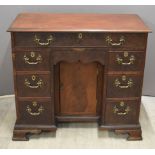 Georgian flame mahogany kneehole desk, fitted eight drawers, one a secret frieze drawer, and