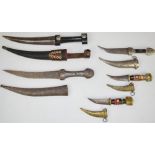 Five various Middle Eastern daggers, all with sheaths, longest blade 19cm. PLEASE NOTE ALL BLADED