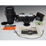 Canon FTb SLR camera with 50mm 1:1.8 lens, further Vivitar 135mm 1:2.8 lens, flash gun, manual etc