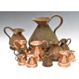 Graduated set of six copper measuring jugs from 2 gallon to half pint, together with six further