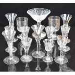 Thirteen various clear glass drinking glasses including air twist and control bubble stems, engraved