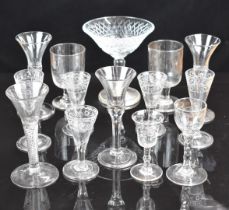 Thirteen various clear glass drinking glasses including air twist and control bubble stems, engraved