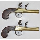 A pair of unnamed flintlock pocket pistols each with brass body, engraved locks, steel trigger