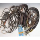 Large quantity of equestrian stirrups, bridles, bits, girth straps and other tack, some items appear