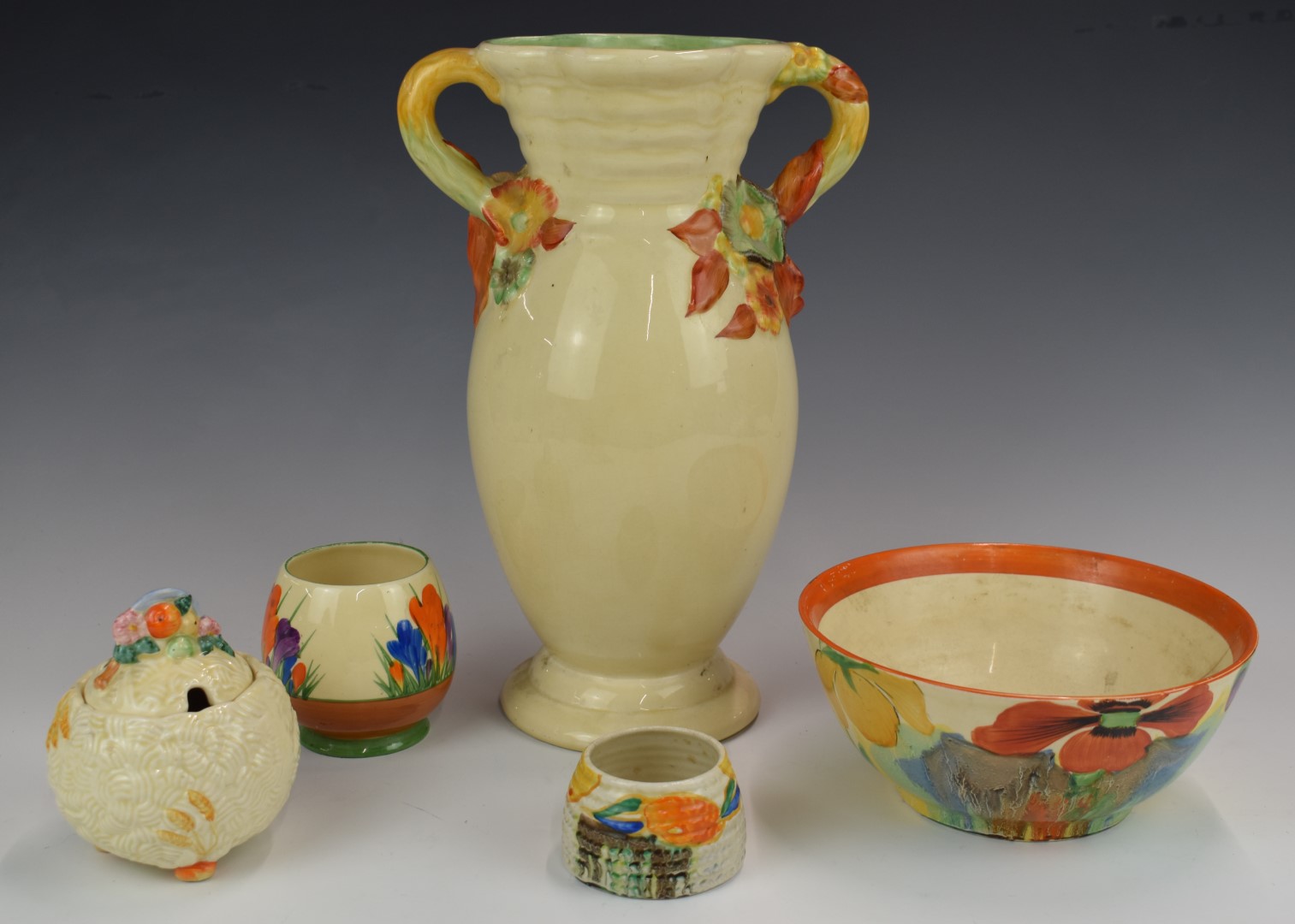 Five pieces of Clarice Cliff / Newport Pottery including Crocus and Delecia patterns, tallest 32cm