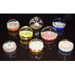 Eight glass paperweights mostly with millefiori decoration, some with latticino canes, including