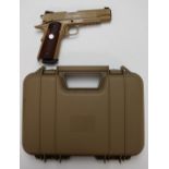 Colt Government .45 automatic Rail Gun style .177 airsoft pistol with faux wooden grips, serial