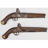 A pair of flintlock pistols each with lock stamped 'Tower' and with crown over 'GR' cypher, line