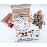 A collection of costume jewellery including faux pearls, brooches, beads, 9ct gold ring, earring and