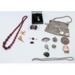 A collection of jewellery including miniature silver hand mirror, Miracle pendant, filigree