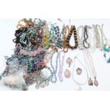 A collection of beaded necklaces including tiger's eye, garnet, agate, glass, opalized beads, silver