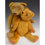 Two English Teddy bears both with golden mohair, straw filling, disc joints, felt pads and