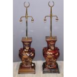 Two Chinese red ceramic lights, with brass finials, height 120cm