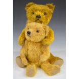 Two Merrythought or similar teddy bears both with golden mohair, straw or similar filling, disc