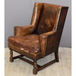 Leather wingback armchair with studded decoration and turned wood legs, width 74cm