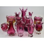 Twelve Bohemia and Murano style cranberry glass vases, largest 31cm tall.