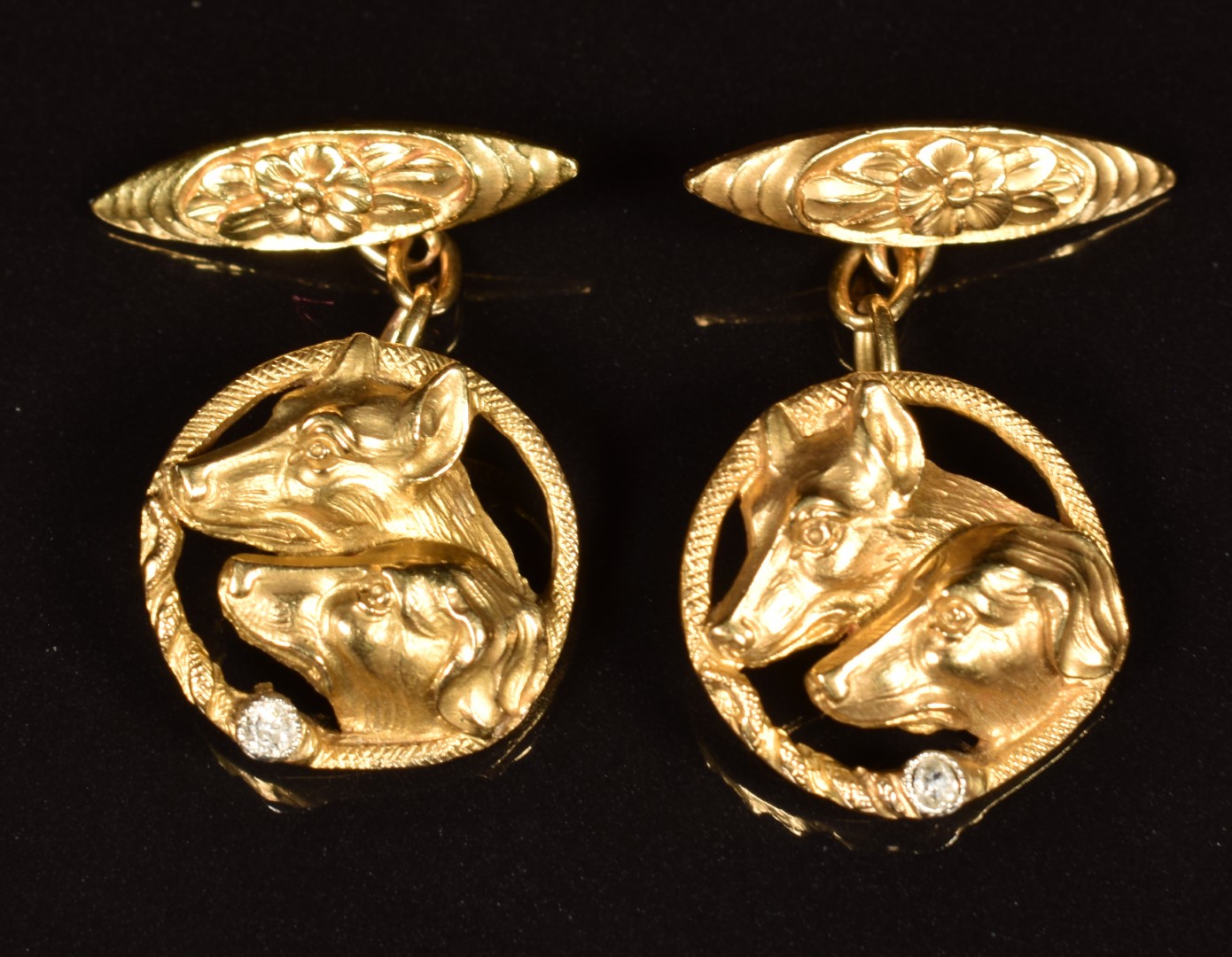 A pair of c1920 18ct gold cufflinks in the form of hounds, each set with a diamond, 10g, in fitted