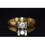 An 18ct gold ring set with a round cut diamond of approximately 0.24ct, 4.6g, size L