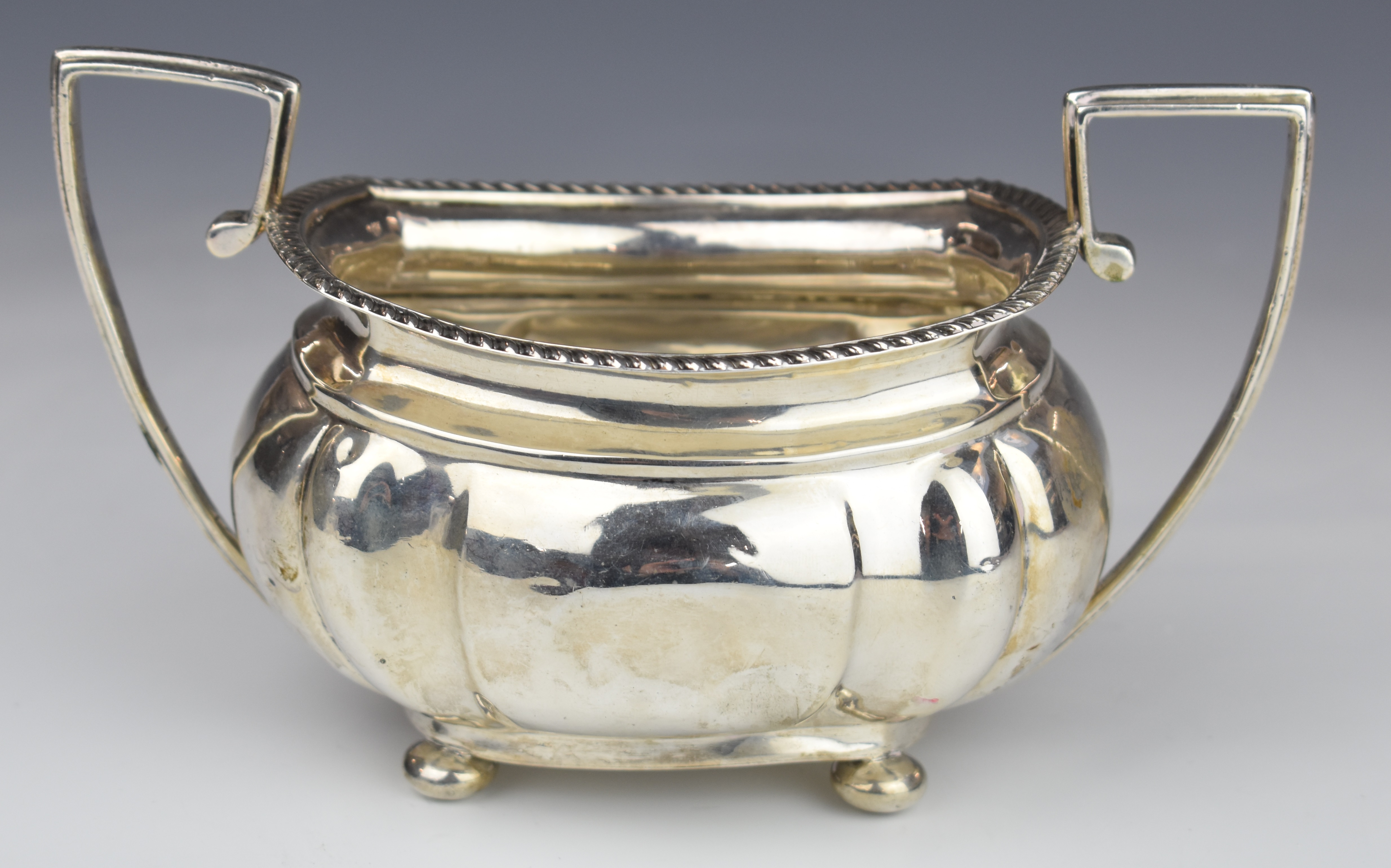 Early 20th century hallmarked silver twin handled sugar bowl with gadrooned edge, raised on four - Image 2 of 6
