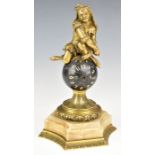 Novelty table clock formed as a jester atop a globe, with gilt metal and marble mounts, height 21.