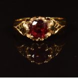 An 18ct gold ring set with a round cut garnet, in antique box, 6.2g