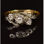 An 18ct gold ring set with three diamonds in a platinum setting, in original box with receipt, 2.3g,