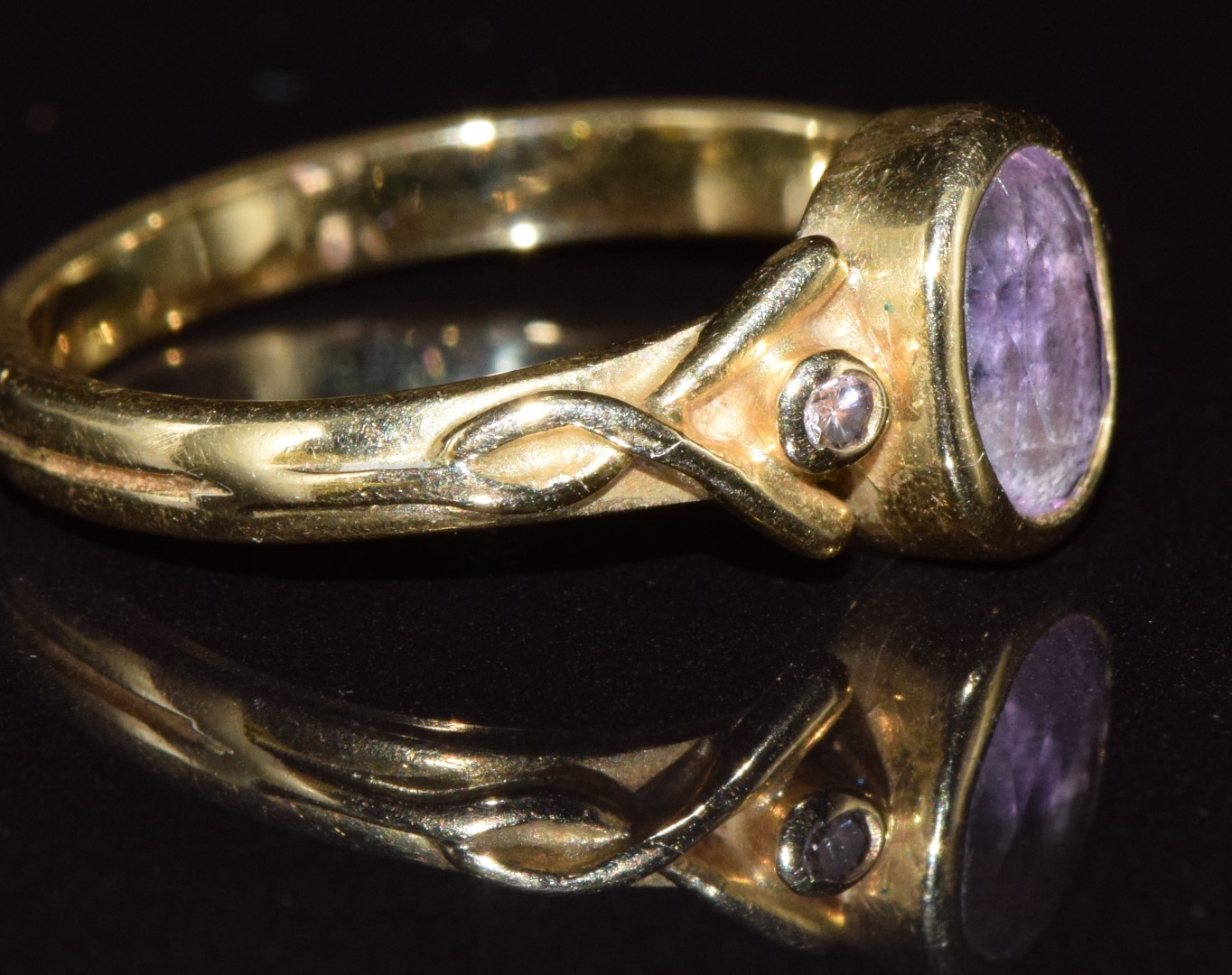 An 18ct gold ring set with an oval cut amethyst and two diamonds, 3.5g, size L - see lot 691 for - Image 2 of 2