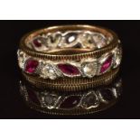 A 9ct gold eternity ring set with marquise cut rubies and spinel, 3.3g