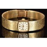 Zenith 9ct gold ladies wristwatch with black hands, two-tone hour markers, silver dial, and signed