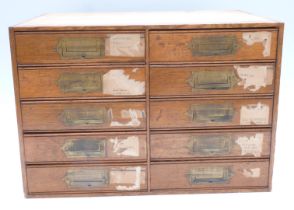 Oak haberdashery jewellery shop cabinet of ten drawers with campaign style handles, some with