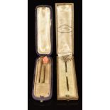 Three Victorian / Edwardian stick pins set with coral and seed pearls, in two vintage boxes