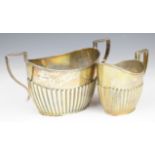 Edward VII hallmarked silver sugar bowl and milk jug both with reeded lower body, Chester 1908,