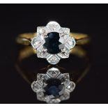 An 18ct gold ring set with a sapphire surrounded by diamonds, 3.5g, size M