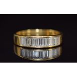 An 18ct gold ring set with nine baguette cut diamonds, each approximately 0.1ct, 3.6g, size O
