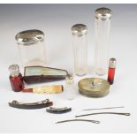 Four hallmarked silver lidded cut glass dressing table bottles, two further red glass bottles,