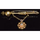 A 14k gold brooch in the form of a orb scepter with a filigree drop section set with an old cut