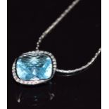 An 18ct white gold pendant set with a blue topaz and diamonds, on 18ct white gold chain, 15.1g